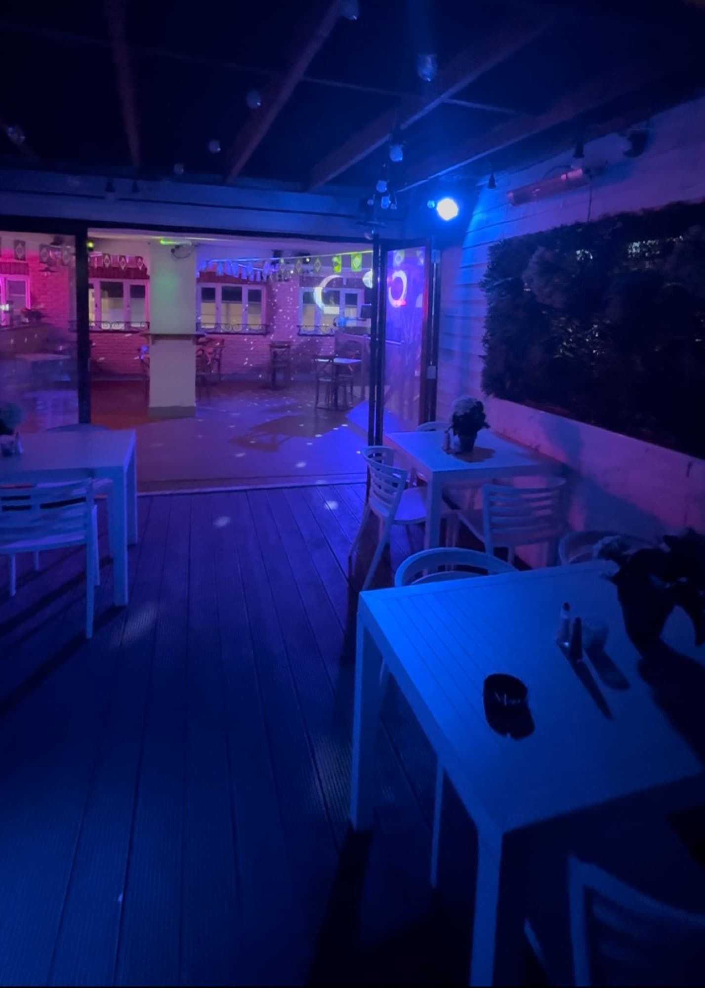 The rooftop terrace at Diego's Rotisserie lit up at night